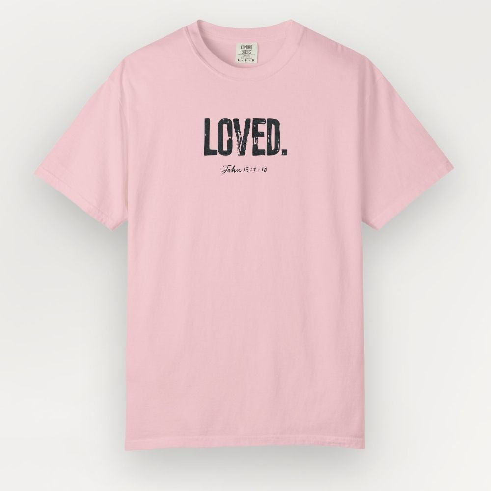 Pink t-shirt with 'LOVED' text on a light gray background