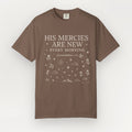 Brown t-shirt with white text and graphics on a white background