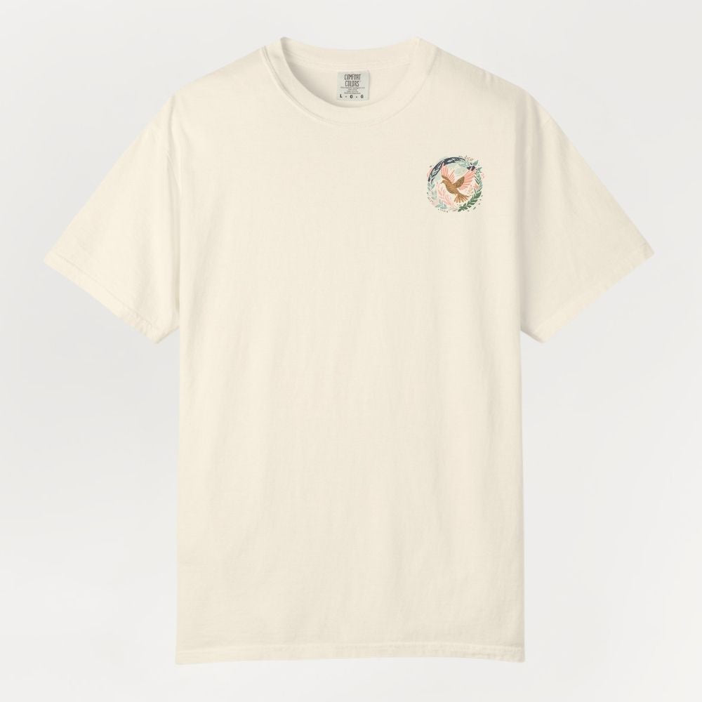 Beige t-shirt with a small colorful logo on a light gray background