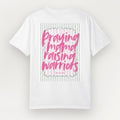 White t-shirt with pink text 'Praying mama raising warriors' on a light gray background