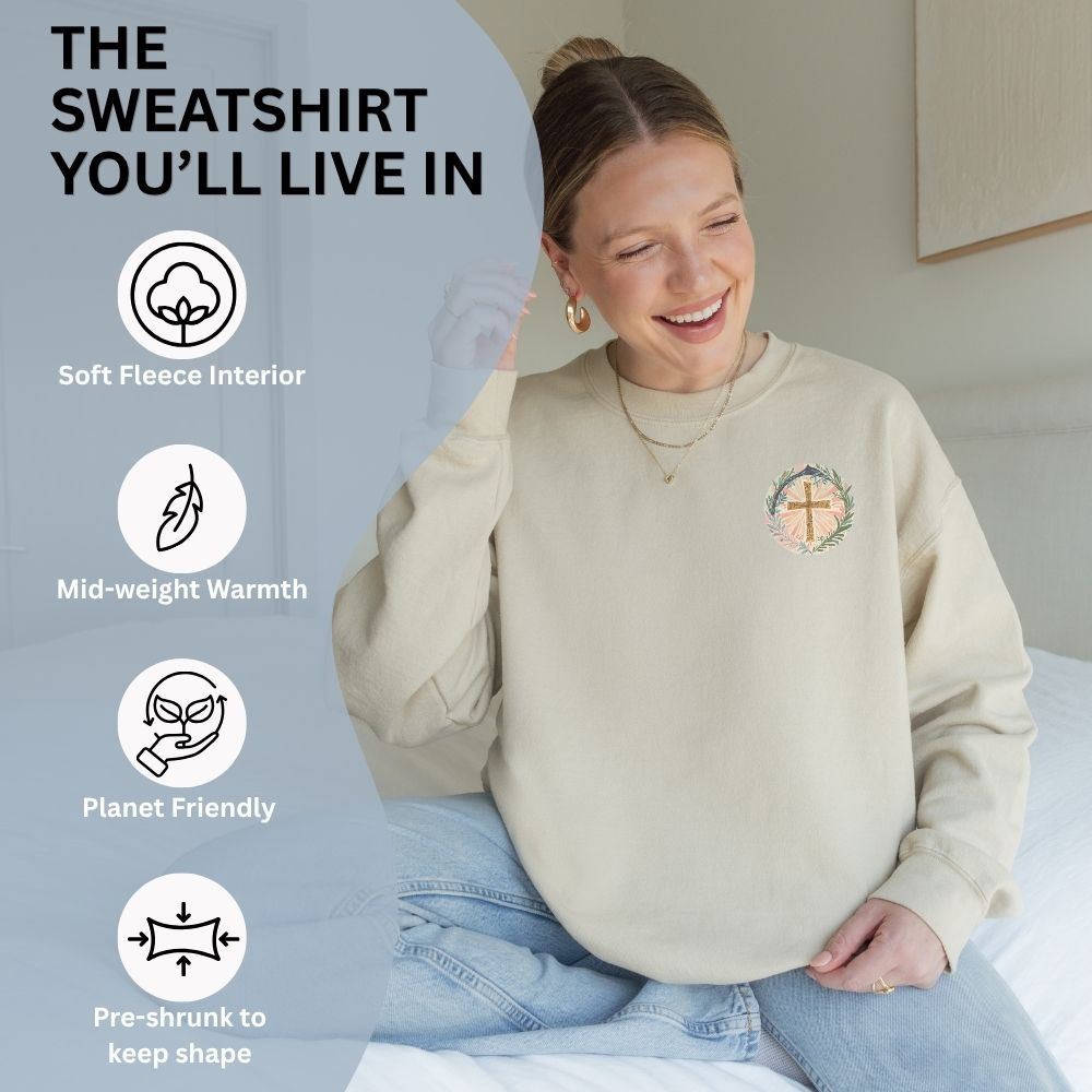 Woman wearing a beige sweatshirt with a logo, sitting on a bed with text highlighting features of the sweatshirt.