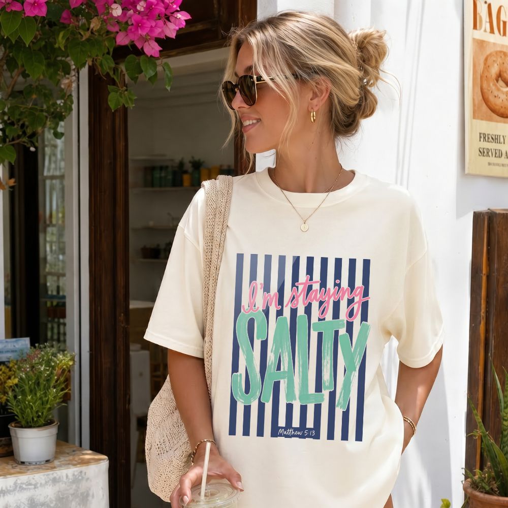 Woman wearing a 'I'm staying Salty' t-shirt in a casual setting.