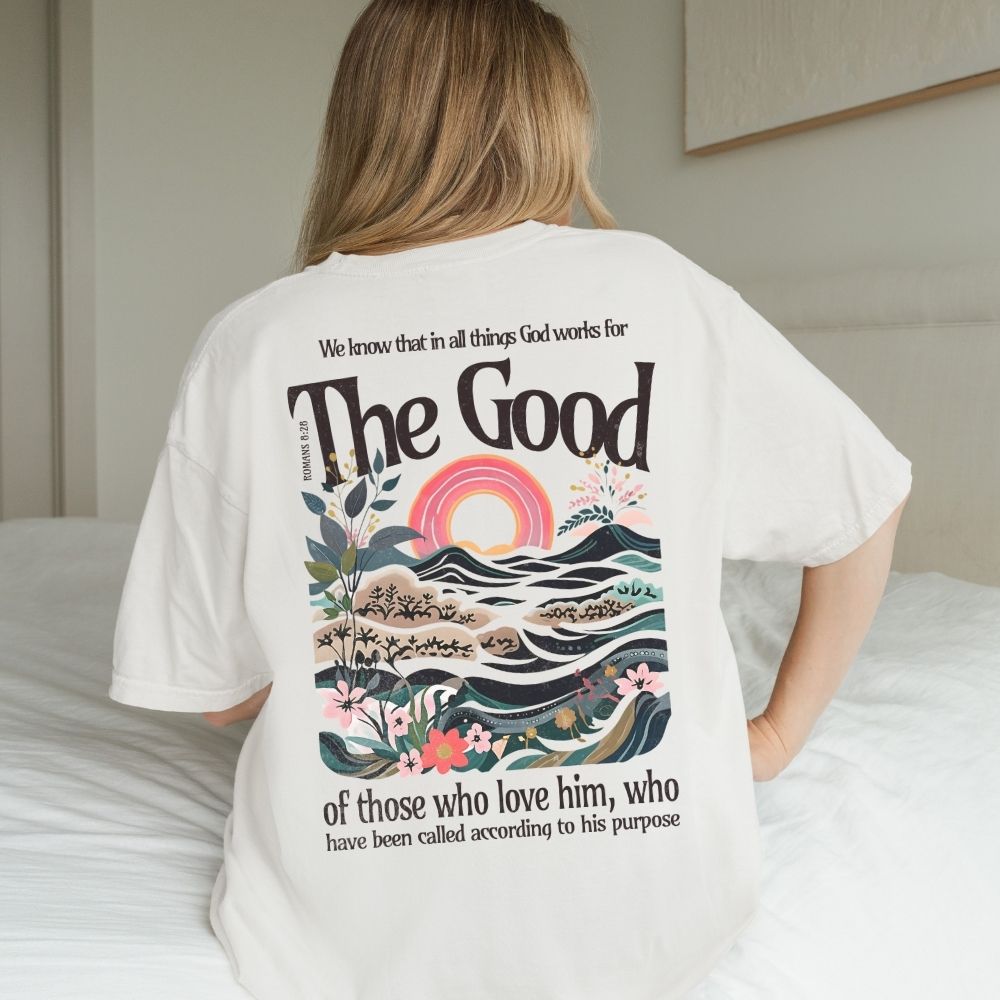 Person wearing a white t-shirt with a colorful design and text on the back.