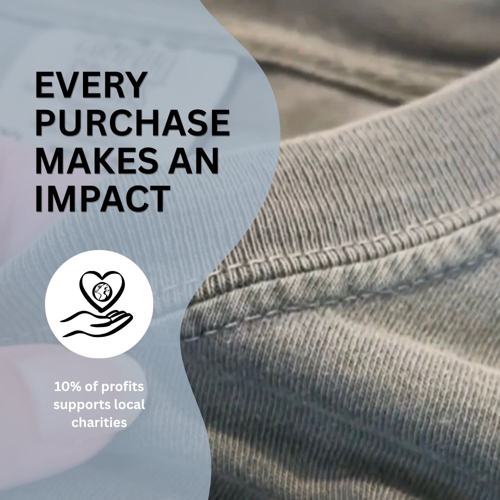 Close-up of jeans with 'Every Purchase Makes an Impact' text and charity logo. The background is the close-up collar of a heavyweight 100% cotton Everyday Faith T shirt