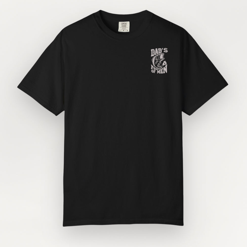 A black Everyday Faith short-sleeve crewneck t-shirt with a small white graphic on the left chest reading 'DAD'S A FISHER OF MEN' with a chef's hat illustration, displayed against a light gray background.