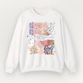 A white Everyday Faith crewneck sweatshirt featuring a colourful graphic collage on the front with religious quotes, floral illustrations, and pastel background blocks.