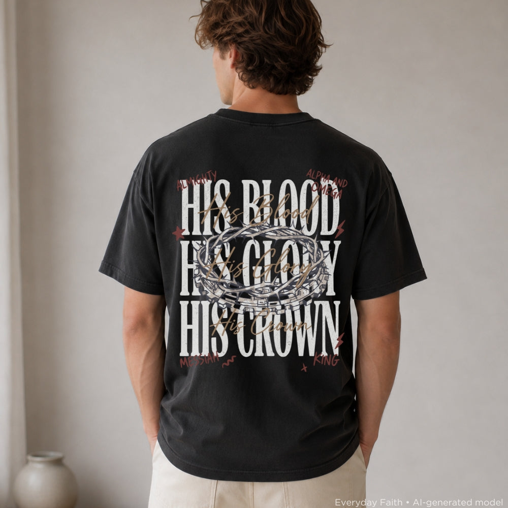 A man viewed from behind wearing a black Everyday Faith graphic t-shirt with the text 'HIS BLOOD HIS GLORY HIS CROWN' in white, overlaid with a silver crown of thorns and small red cross motifs. He is wearing light beige pants in a minimalist indoor setting.