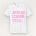 A white short-sleeve Everyday Faith crewneck t-shirt with the phrase 'JESUS LOVES YOU.' printed in bold pink capital letters across the chest, displayed against a light off-white background.