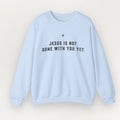 A light blue Everyday Faith crewneck sweatshirt with the text 'JESUS IS NOT DONE WITH YOU YET' printed in black across the chest, displayed on a clean, light beige background.
