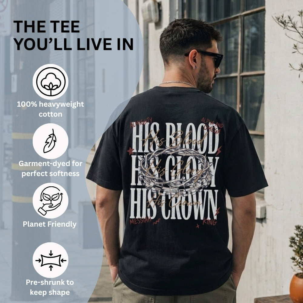 A man wearing a black Everyday Faith graphic t-shirt from the back, standing outdoors next to a building wall. The t-shirt features a large white distressed graphic reading 'HIS BLOOD HIS GLORY HIS CROWN' with a crown illustration in the center.