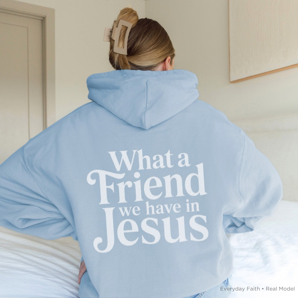 Person wearing a light blue Everyday Faith hoodie with 'What A Friend We Have In Jesus' text on the back.