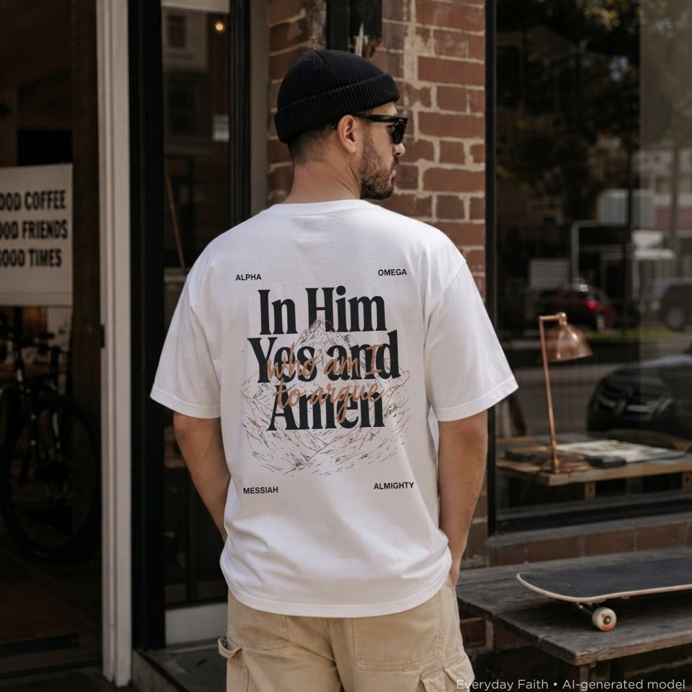 A man wearing a white Everyday Faith t-shirt with a large black and gold graphic print on the back, standing in front of a brick storefront.
