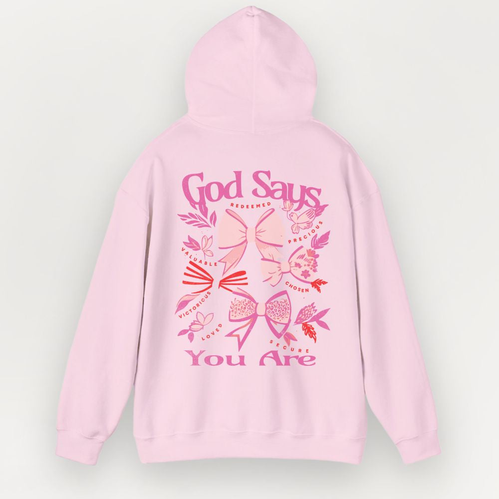 Pink hoodie with decorative text and designs on a light gray background