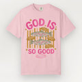 Pink t-shirt with fish and bread graphic and 'God is so good' text on a white background