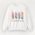 A white Everyday Faith crewneck sweatshirt featuring a colourful watercolor floral graphic and the text 'It is well with my soul' printed on the front, displayed against a light off-white background.