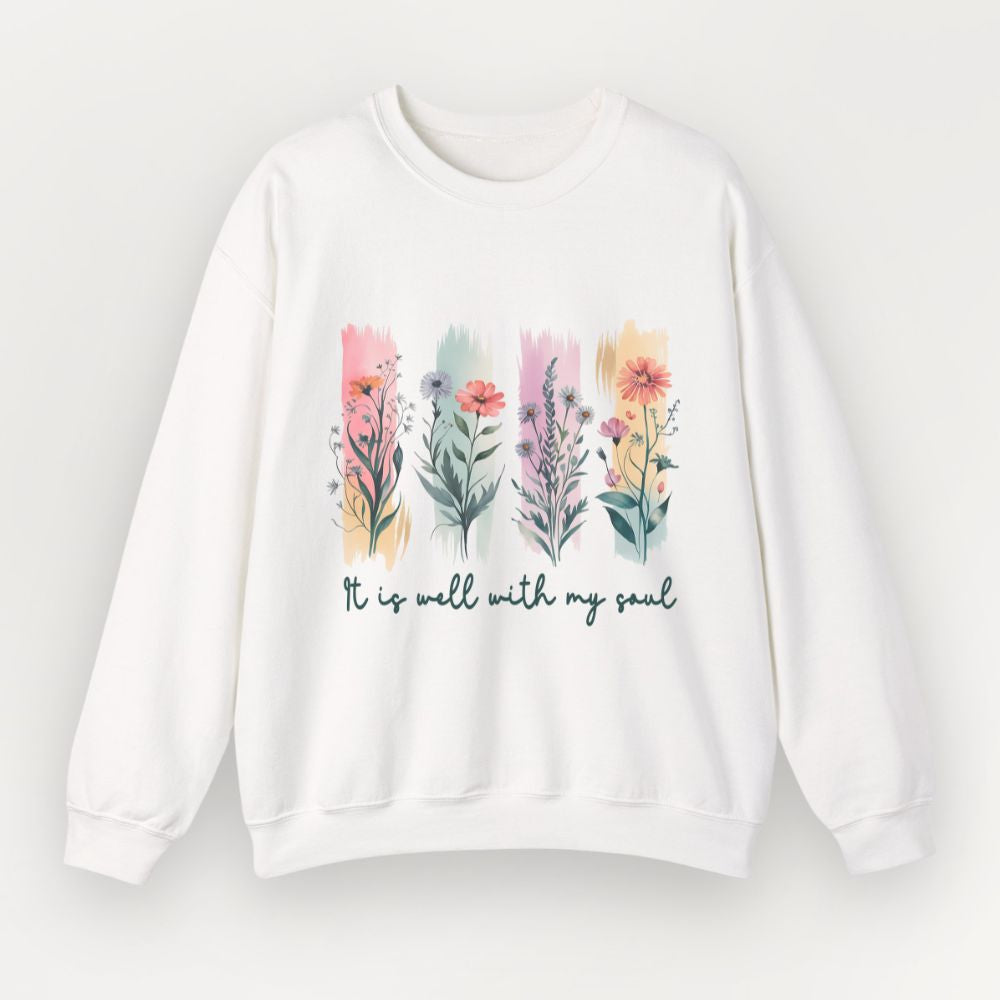 A white Everyday Faith crewneck sweatshirt featuring a colourful watercolor floral graphic and the text 'It is well with my soul' printed on the front, displayed against a light off-white background.