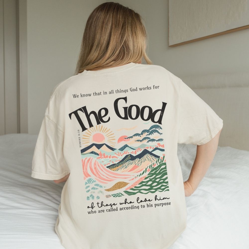 Person wearing a t-shirt with a scenic design and text on the back