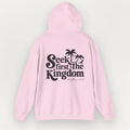 Pink hoodie with 'Seek first the Kingdom' text on a light gray background