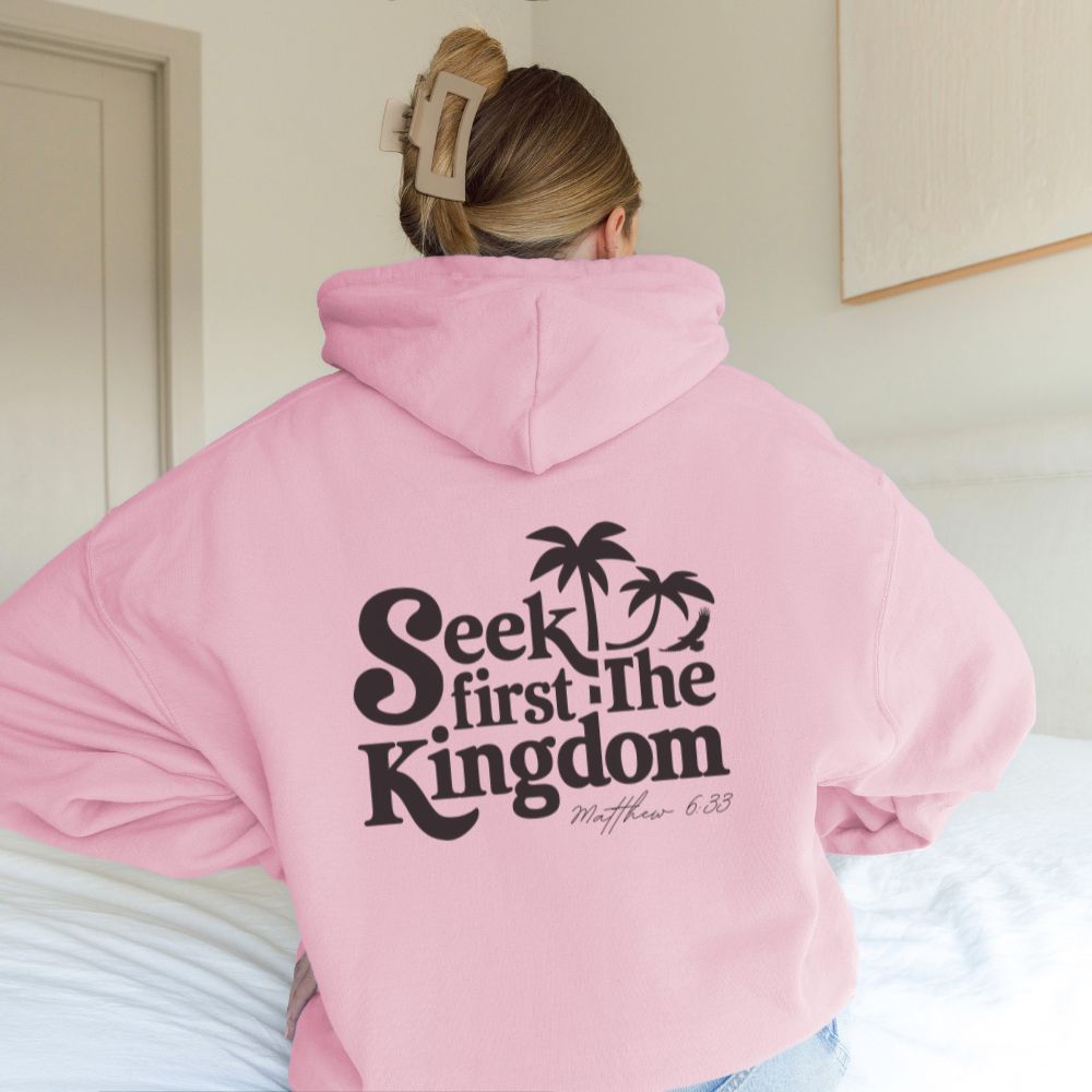 Person wearing a pink hoodie with 'Seek first the Kingdom' text on the back.