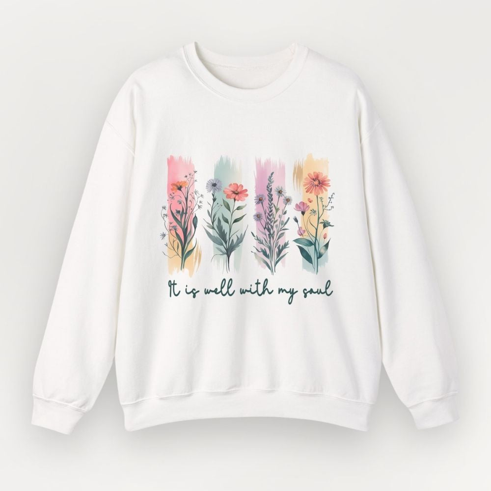 White sweatshirt with floral design and text 'It is well with my soul' on a light gray background