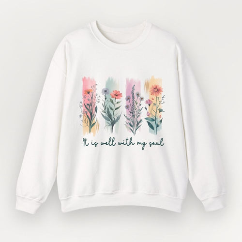 White sweatshirt with floral design and text 'It is well with my soul' on a light gray background