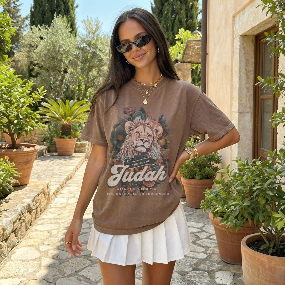 Woman wearing a Lion of Judah Christian t-shirt artwork with lion illustration and scripture text