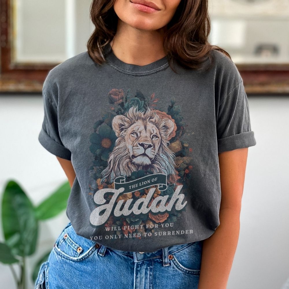 Faith t-shirt with lion design and scripture from Exodus and Revelation. Christian women’s t-shirt symbolizing victory and strength in faith