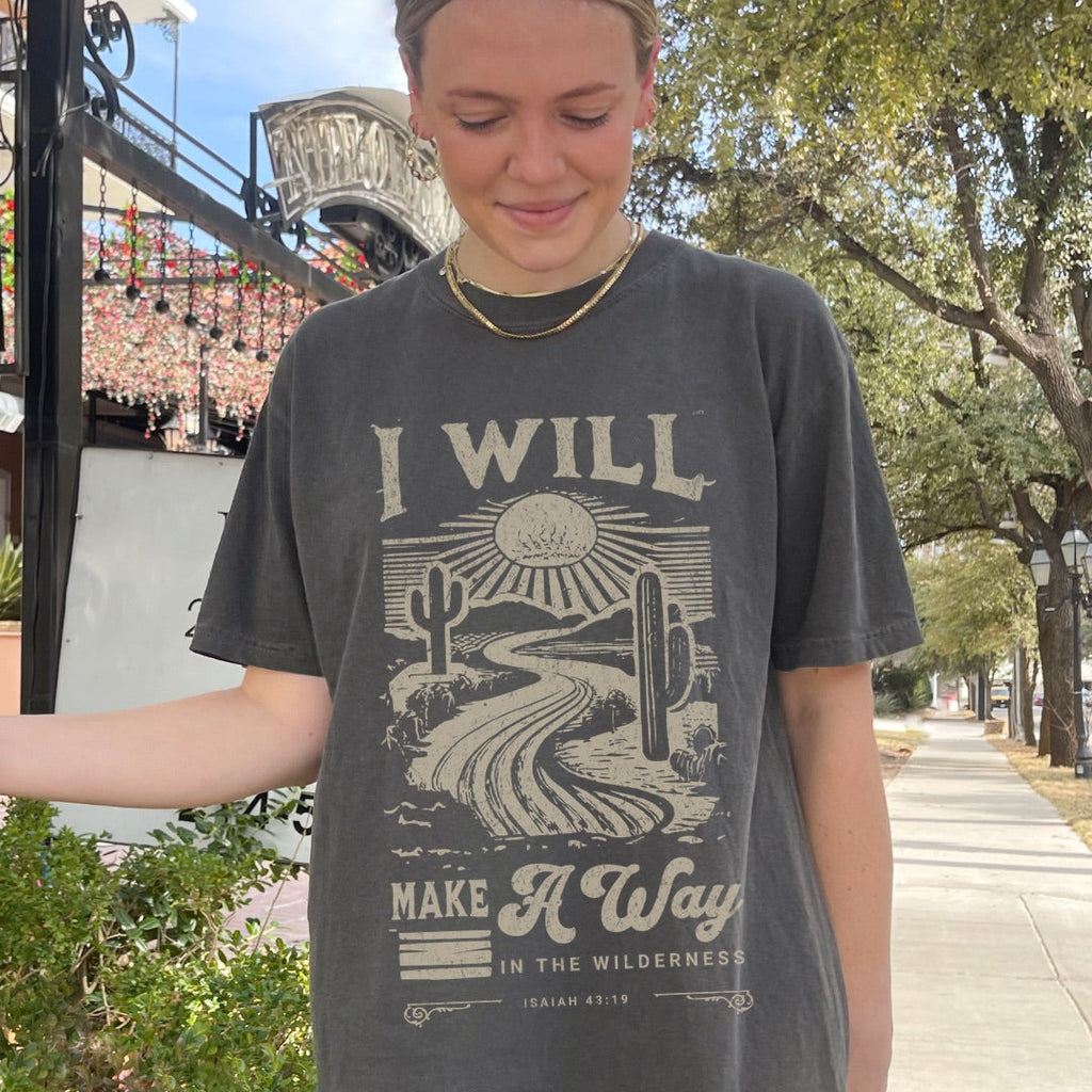 A faith-inspired Christian tee featuring Isaiah 43:19. Designed to remind you that God makes a way, even in the wilderness.