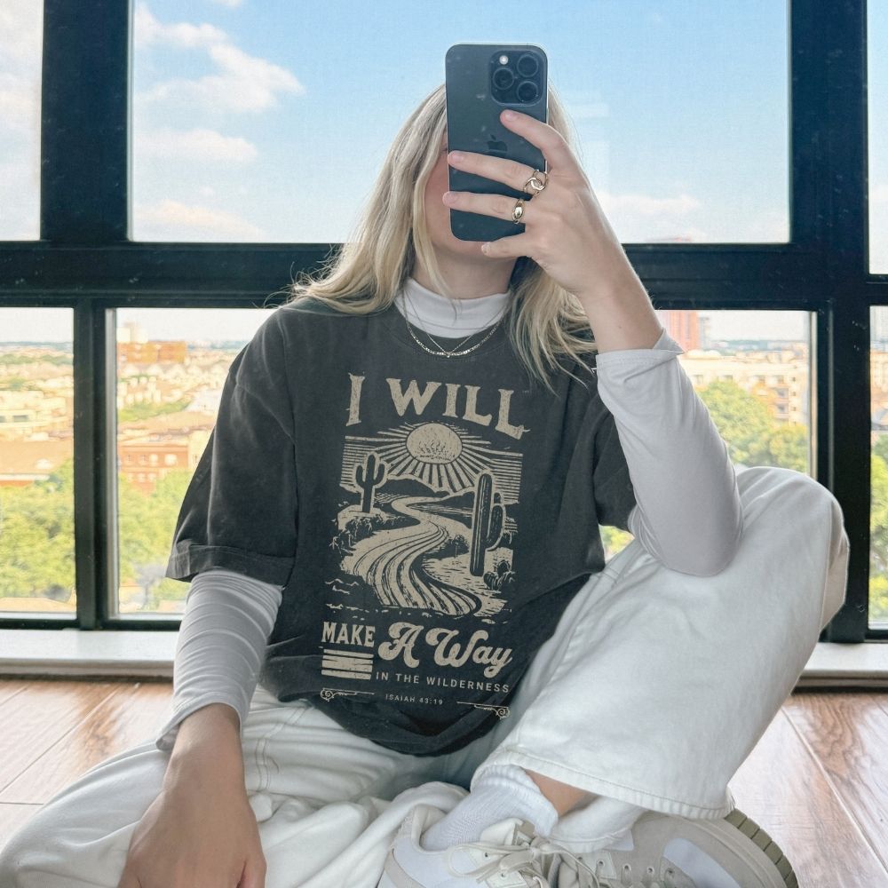 A faith-inspired Christian tee featuring Isaiah 43:19. Designed to remind you that God makes a way, even in the wilderness.