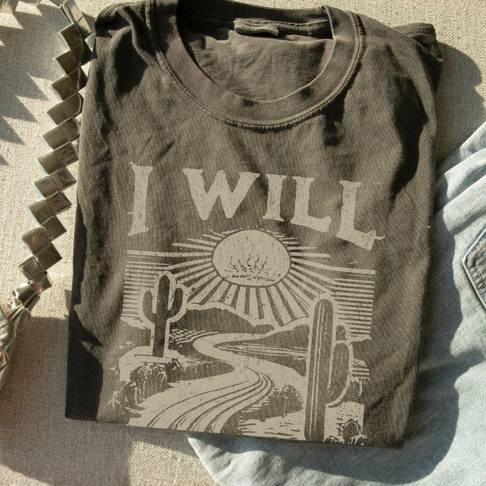 A faith-inspired Christian tee featuring Isaiah 43:19. Designed to remind you that God makes a way, even in the wilderness.