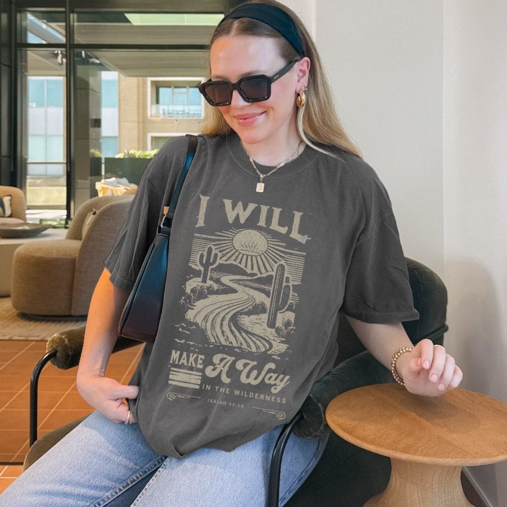 A faith-inspired Christian tee featuring Isaiah 43:19. Designed to remind you that God makes a way, even in the wilderness.